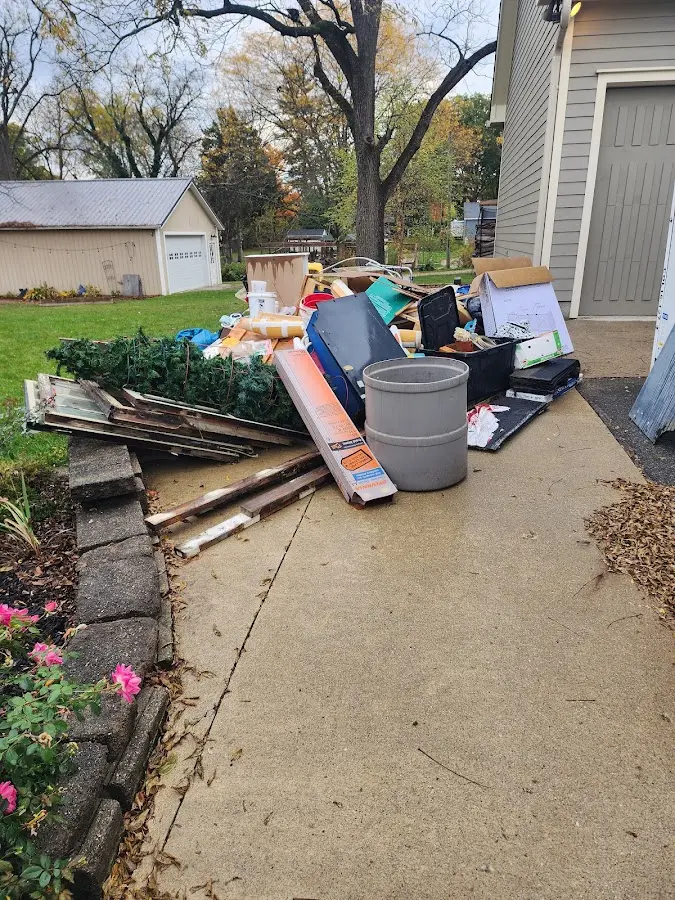 Dumpster being loaded with debris for Estate Cleanout Dumpster Rental in Citrus Park